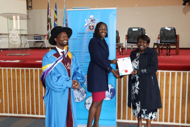 (Center) Dr. Millicent Masinde being awarded