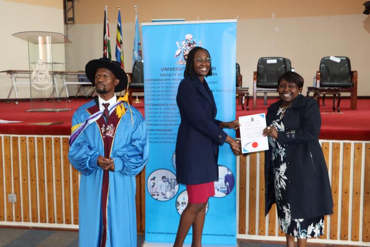 (Center) Dr. Millicent Masinde being awarded