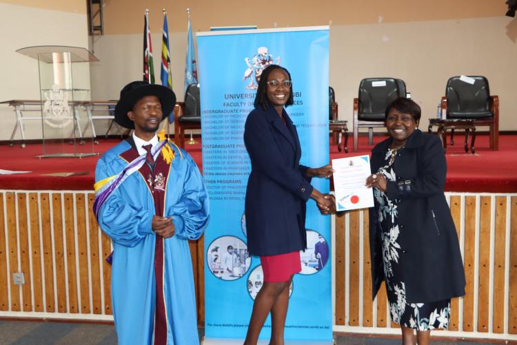 (Center) Dr. Millicent Masinde being awarded